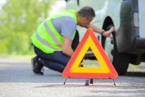 Emergency stop sign and man near broken car outdoors